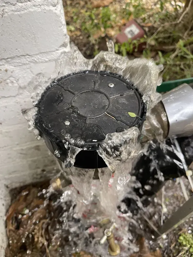 Water is coming out of a hole in a pipe.