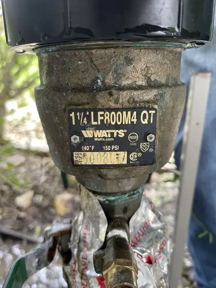 A close up of a metal object with a label on it.