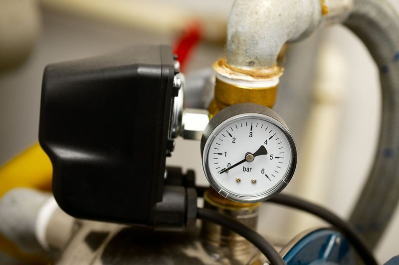 A close up of a pressure gauge on a water pump.