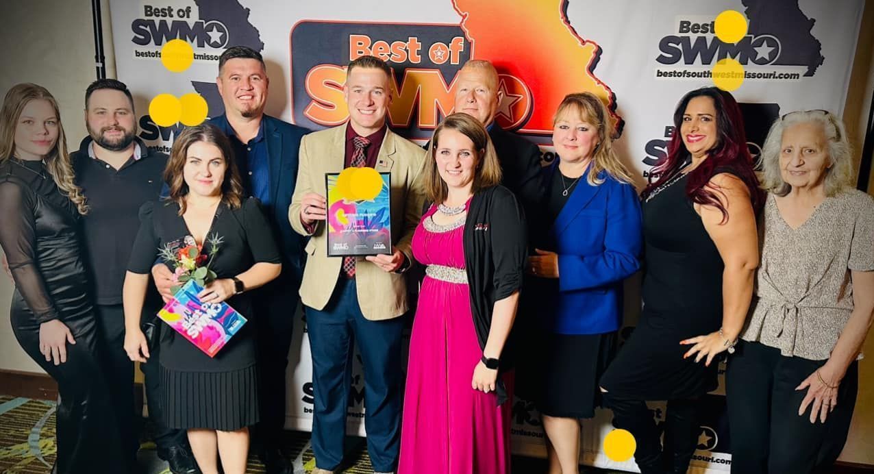 Group of people smiling, holding awards at Best of SWMO event.