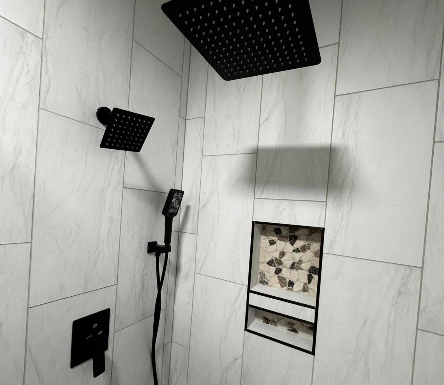 A shower with a black shower head and a black shower head