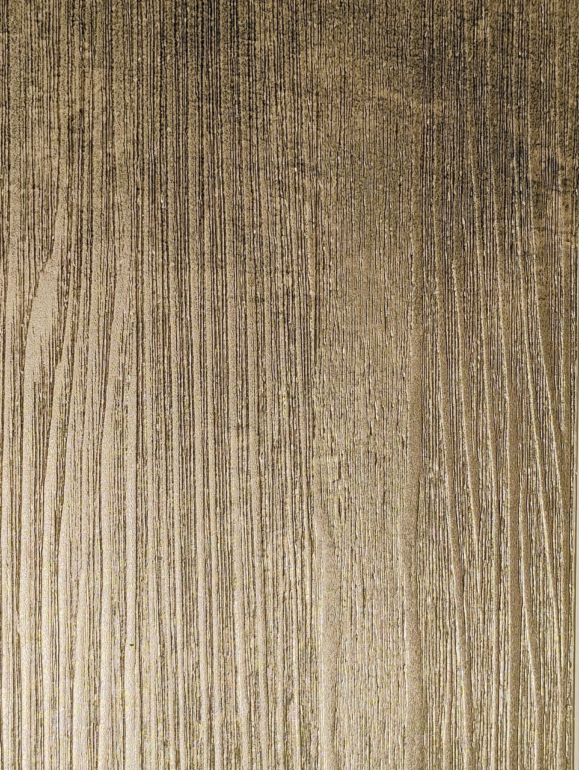 Assorted wooden sample squares in various shades of brown, gray, and cream, displayed on a dark surface.