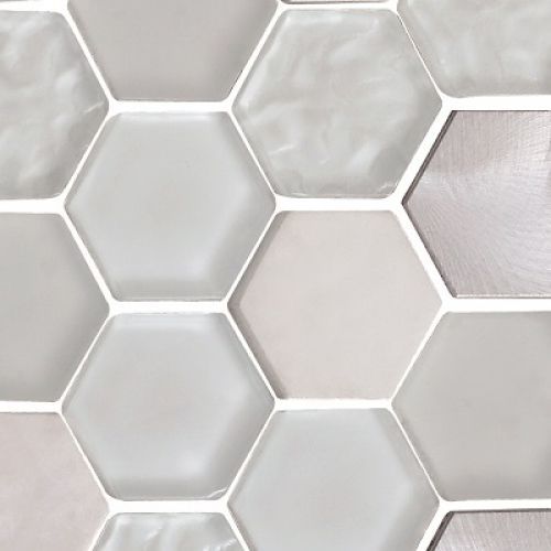 Close-up of a mosaic tile with hexagon shapes in varying shades of white and gray.