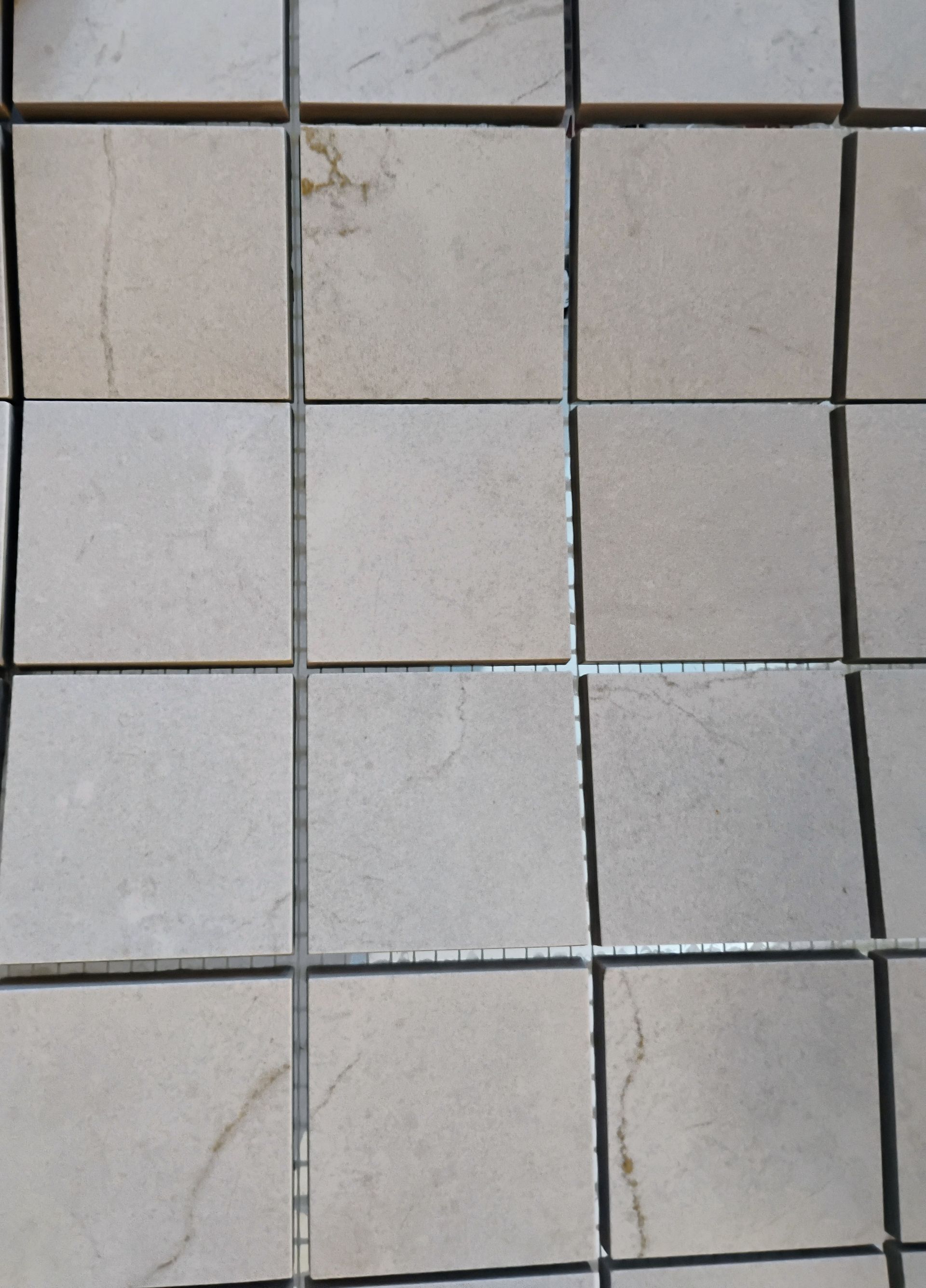 Various wood-look samples in shades of brown, gray, and beige, arranged on a dark surface.