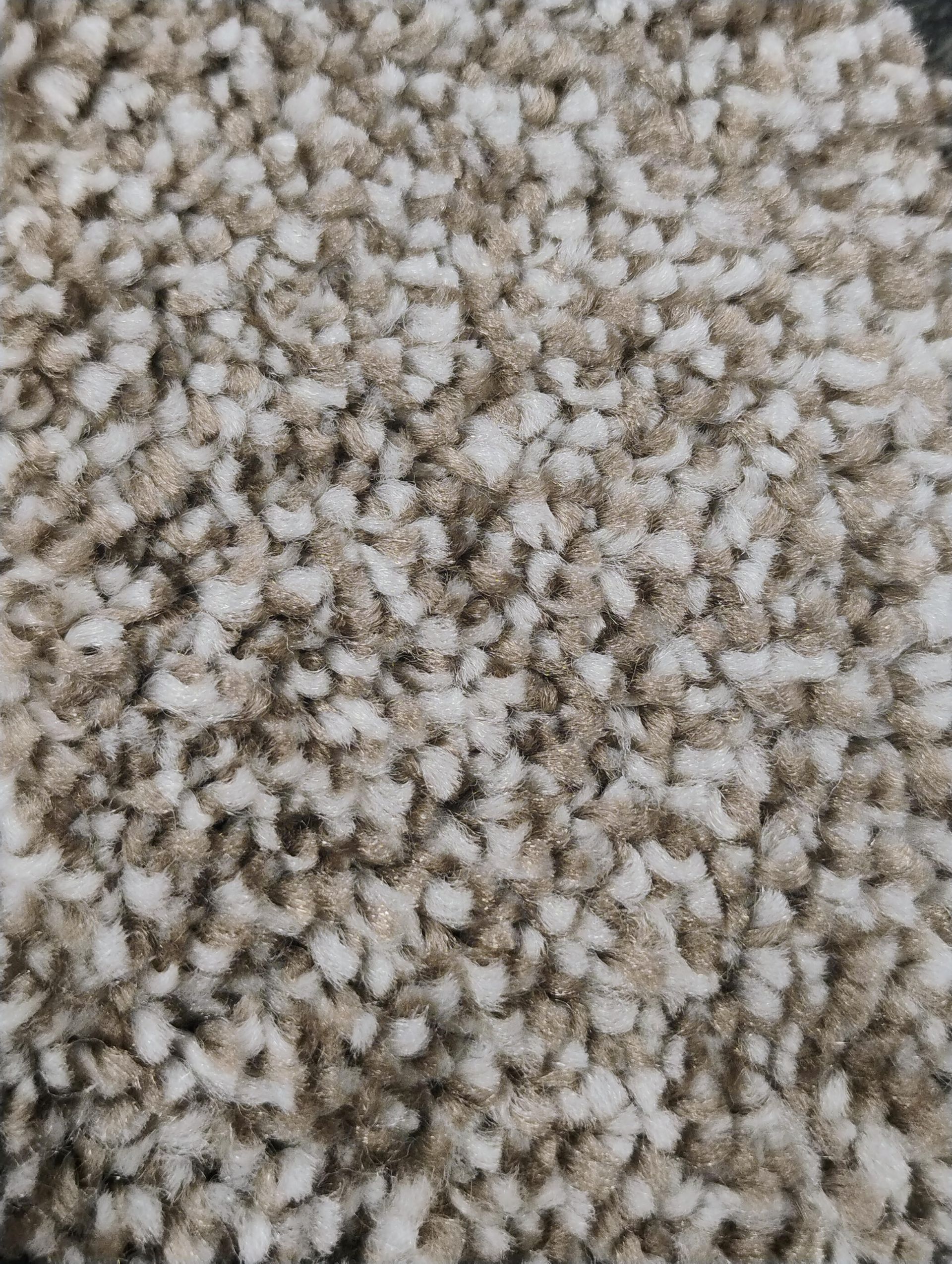 Assorted wooden sample squares in various shades of brown, gray, and cream, displayed on a dark surface.