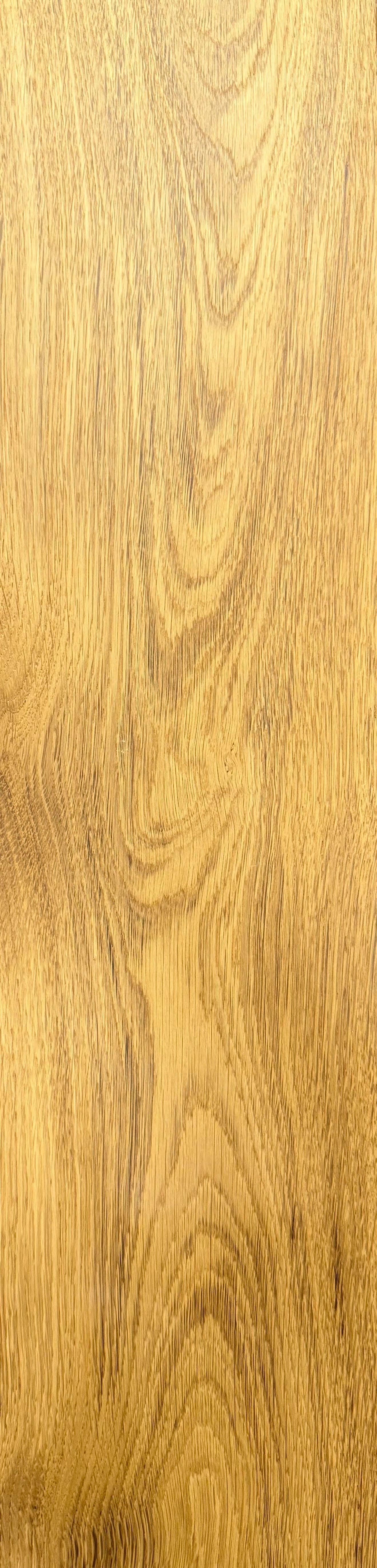 Close-up of a wood grain pattern in shades of gold and brown.
