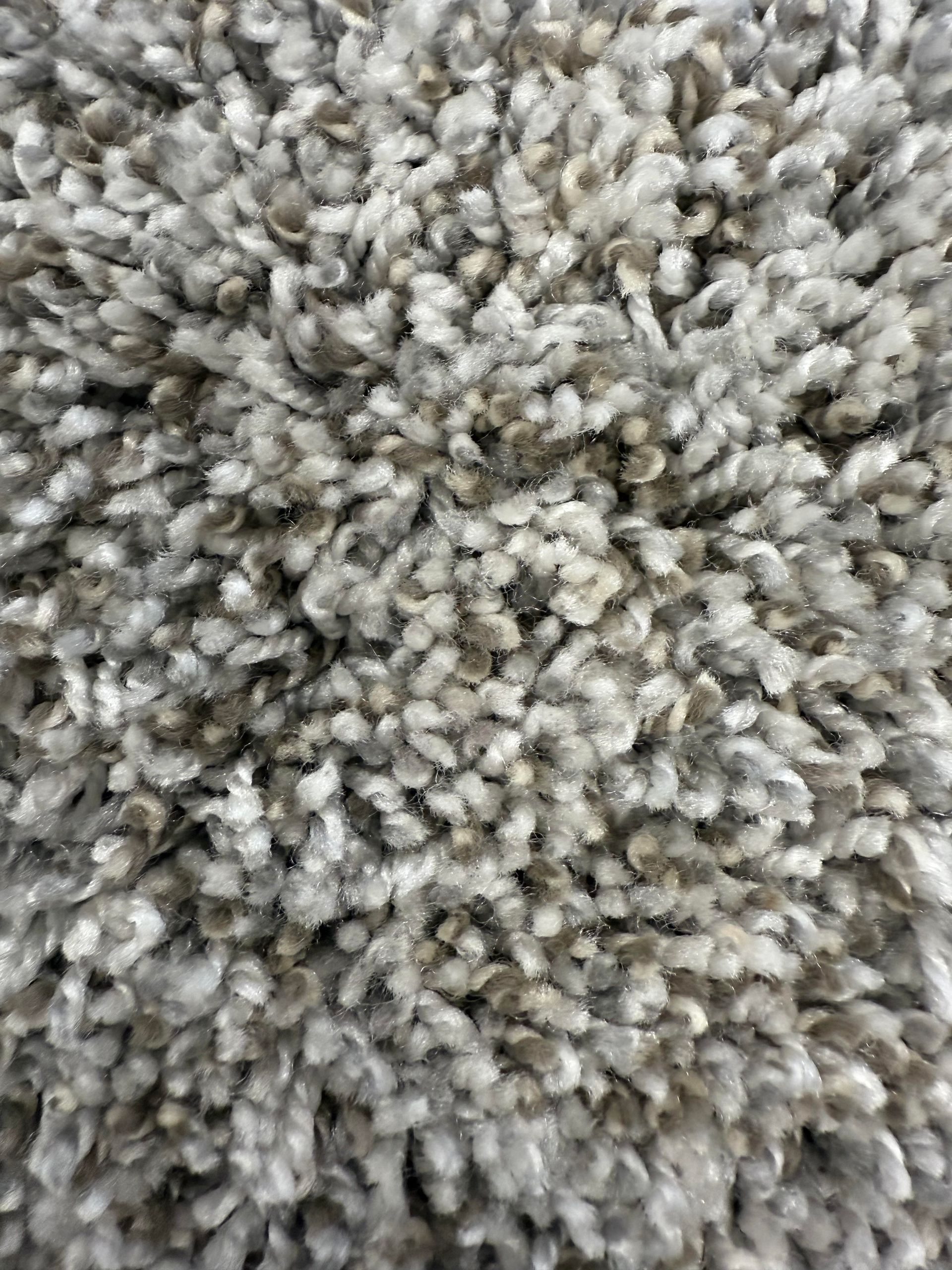 Close-up of a gray and white textured carpet.