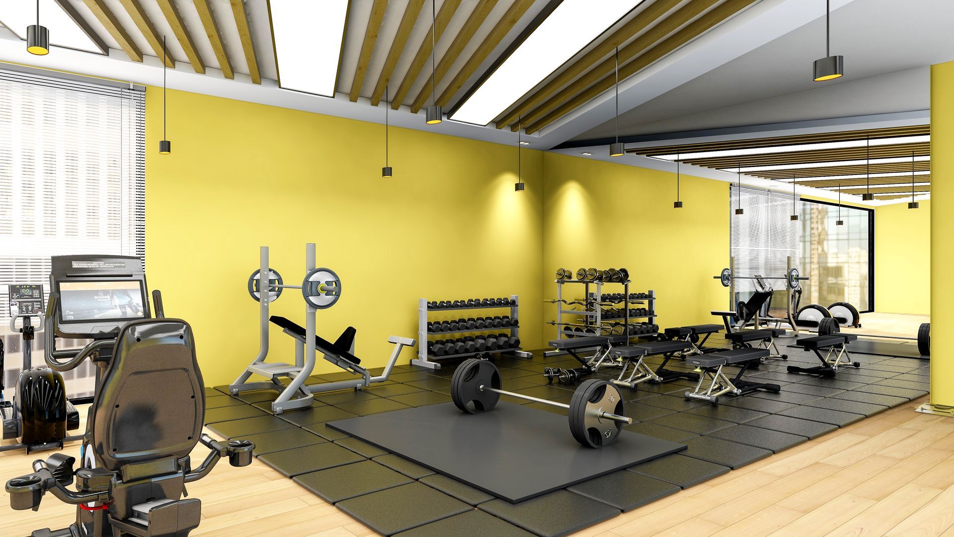 A gym with a lot of equipment and yellow walls.