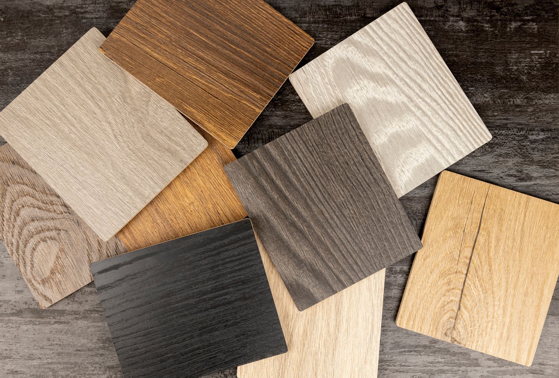 There are many different types of wood samples on the table.