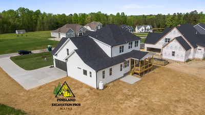 An aerial view of a house under construction in a residential area.