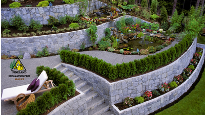 A stone wall surrounds a lush green garden