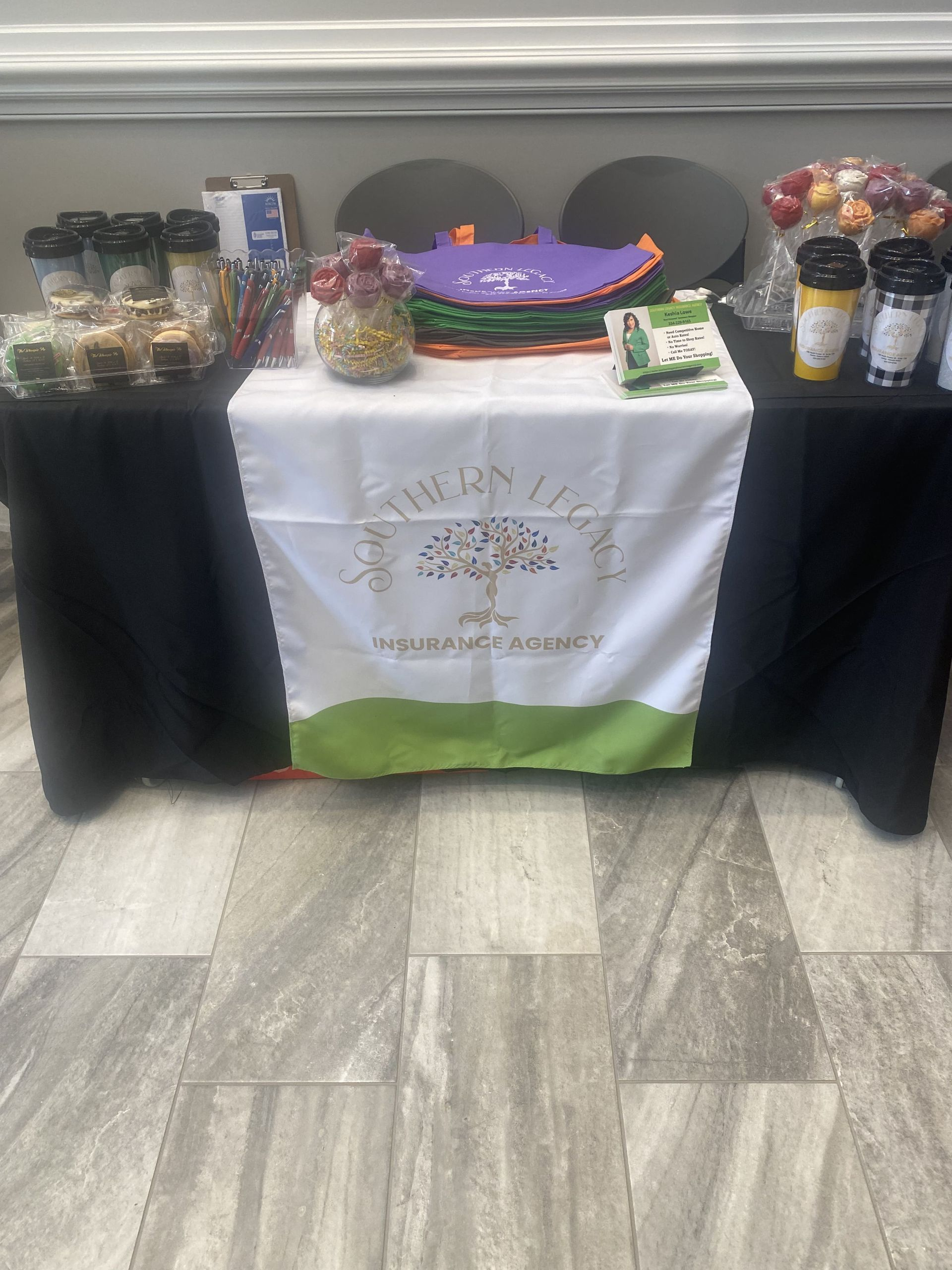 A table with a black table cloth and a white table cloth with a tree on it.