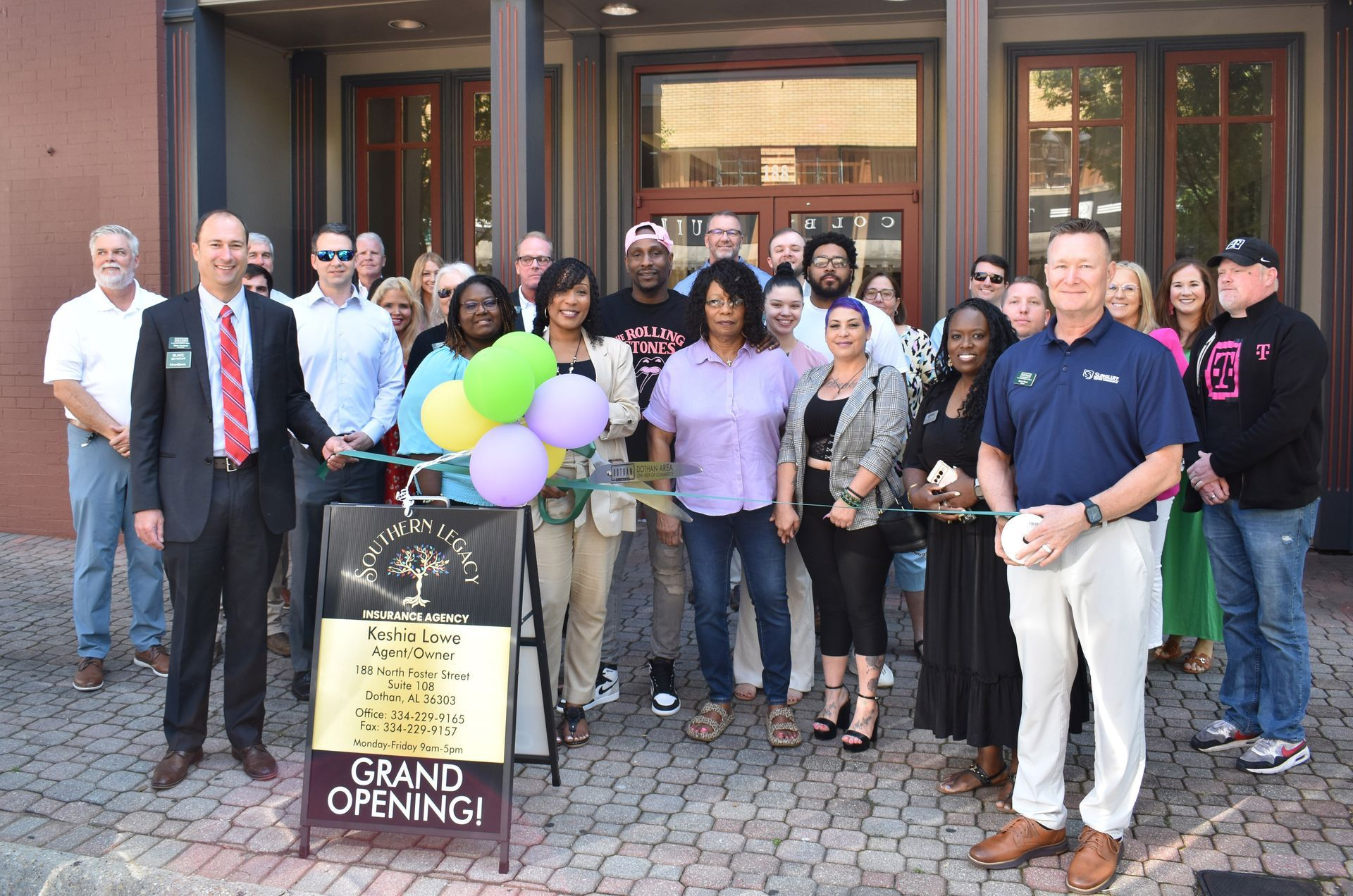 A group of people are standing in front of a building.