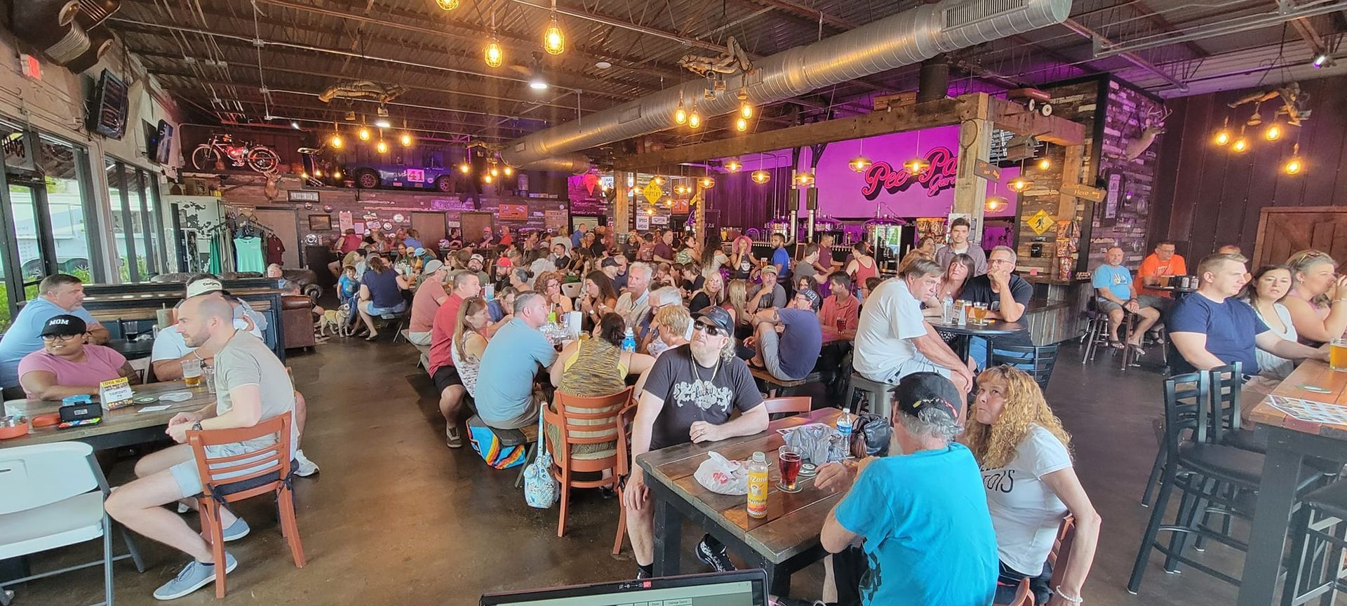A large group of people are sitting at tables in a restaurant.