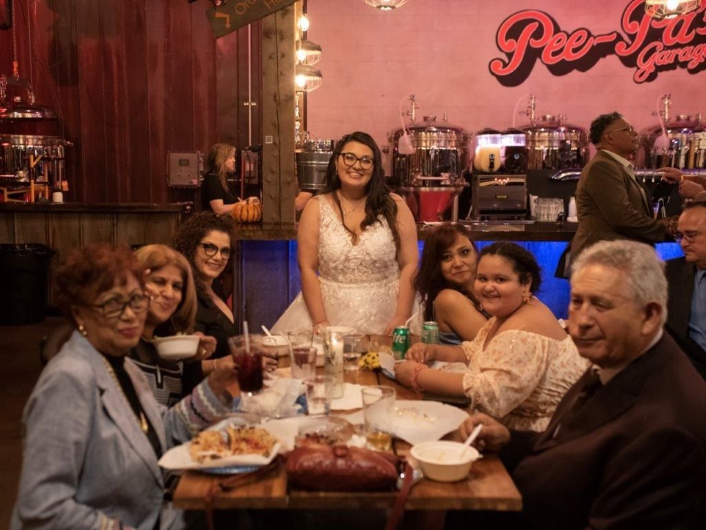 A group of people are sitting at a table in a restaurant.