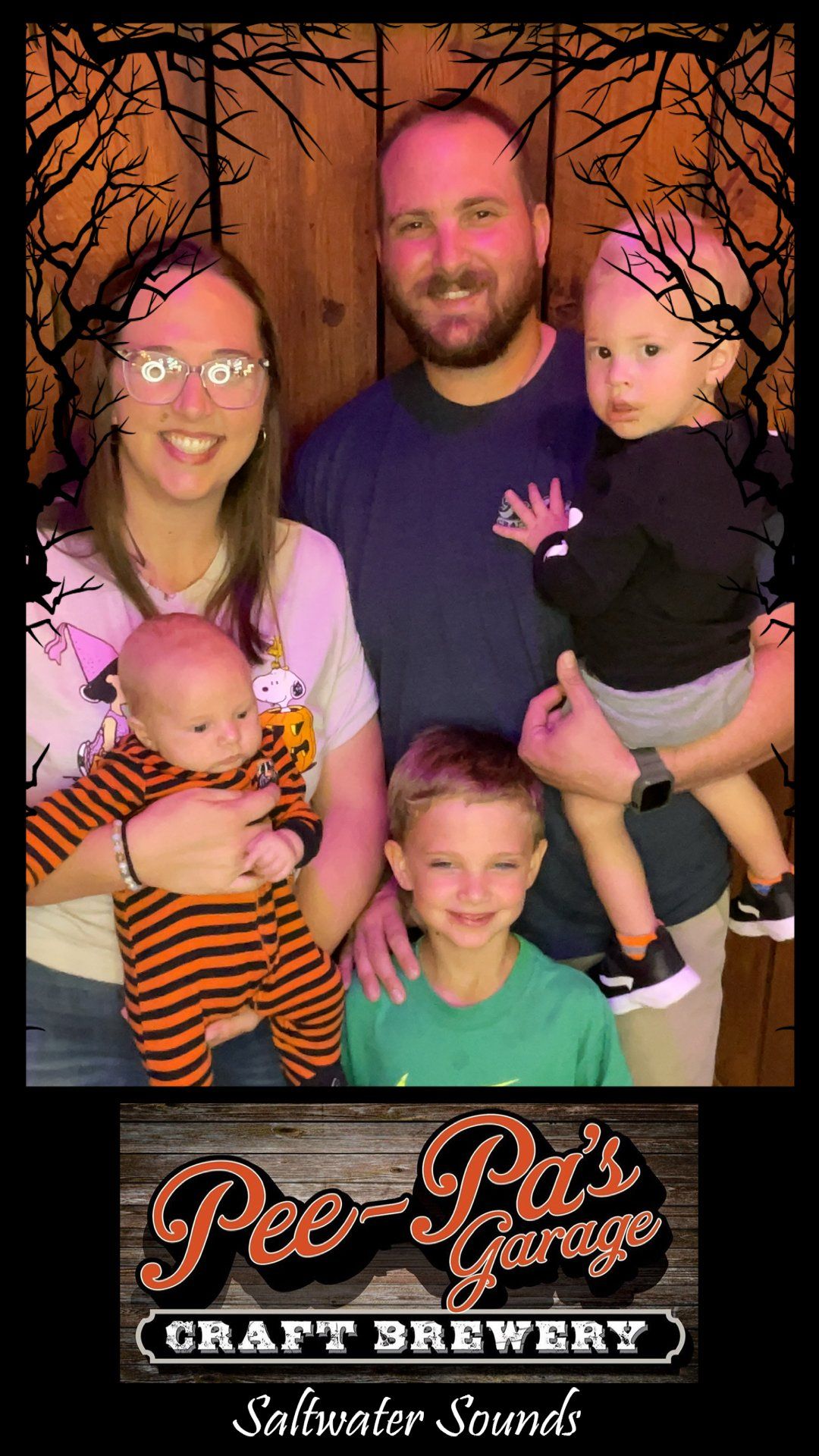 A family is posing for a picture at a craft brewery.
