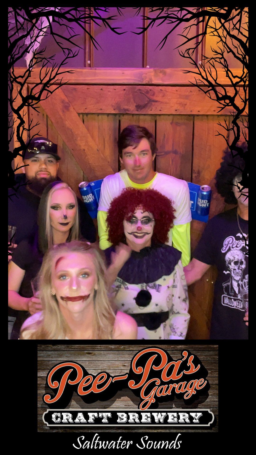 A group of people dressed in halloween costumes are posing for a picture.