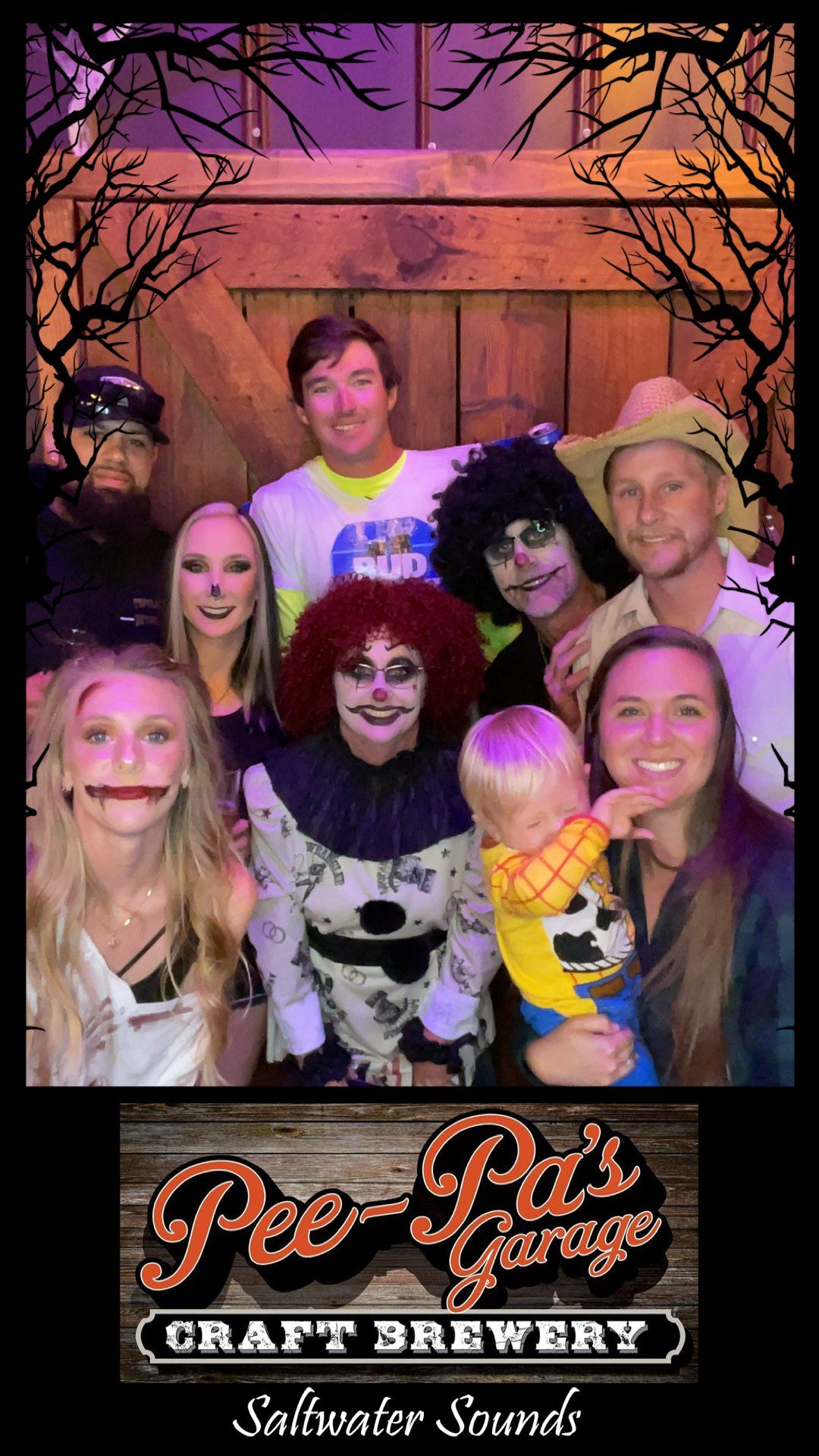 A group of people dressed in halloween costumes are posing for a picture.