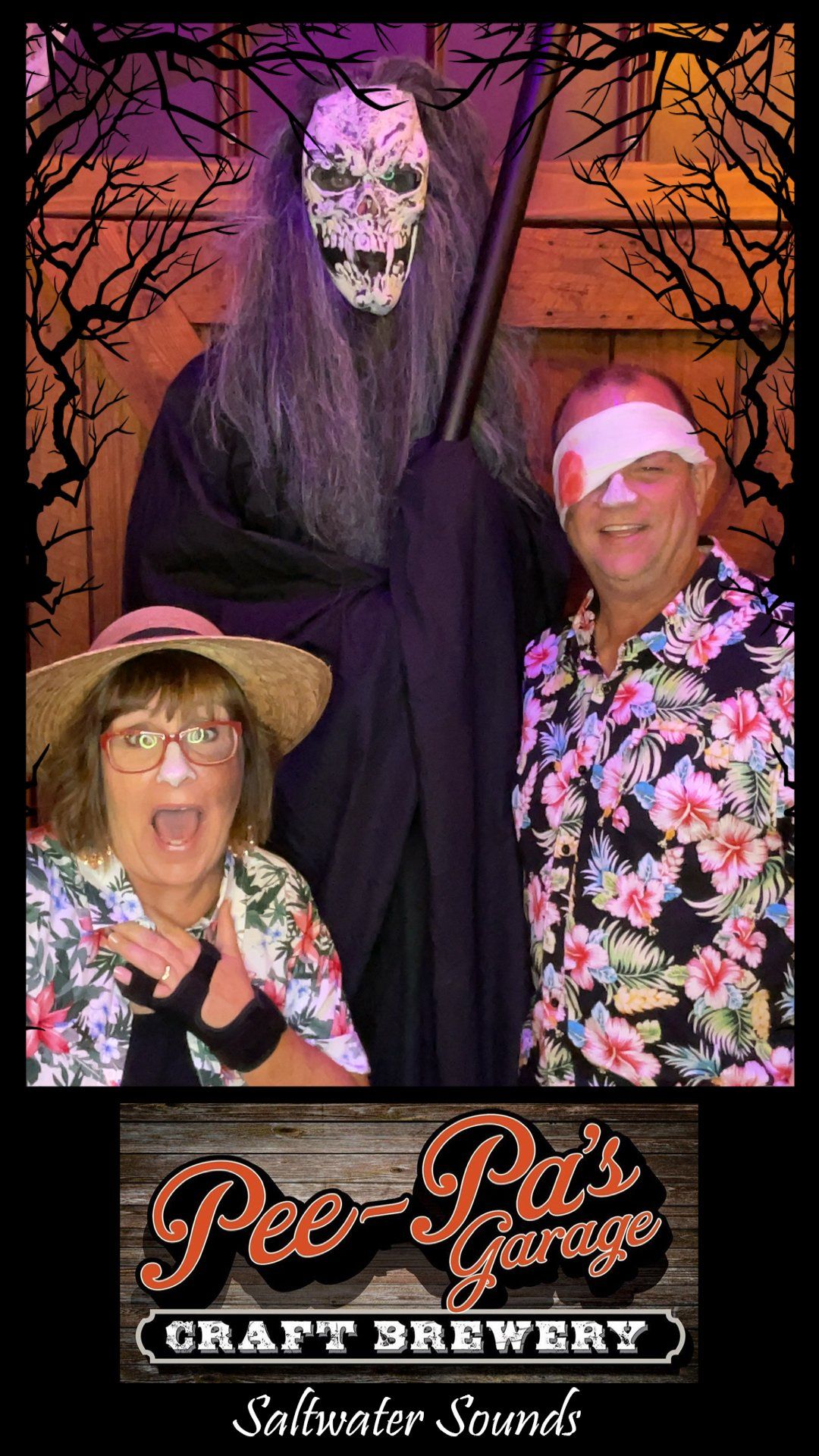 A man and a woman are posing for a picture with a grim reaper.