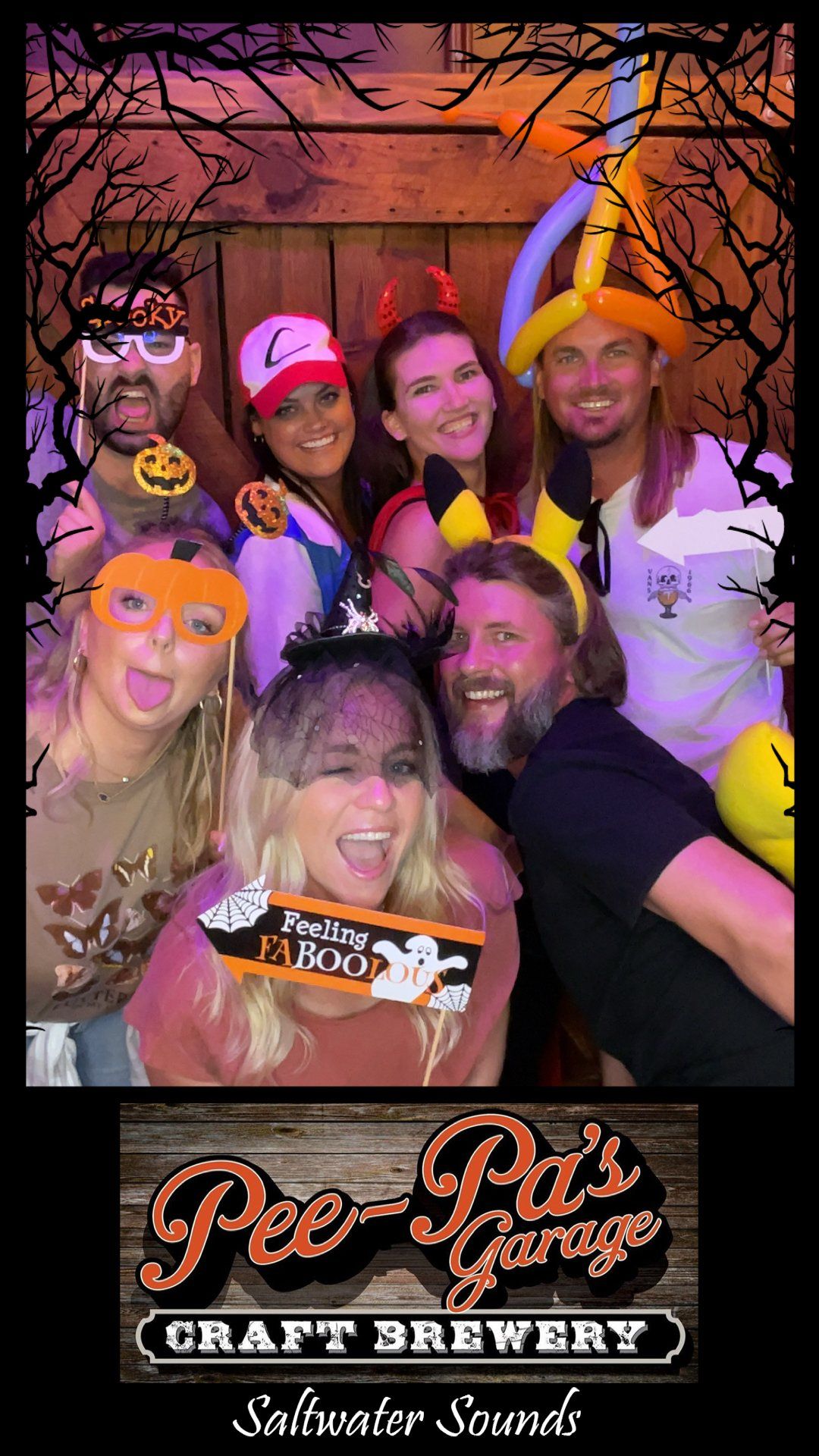 A group of people are posing for a picture in a photo booth.