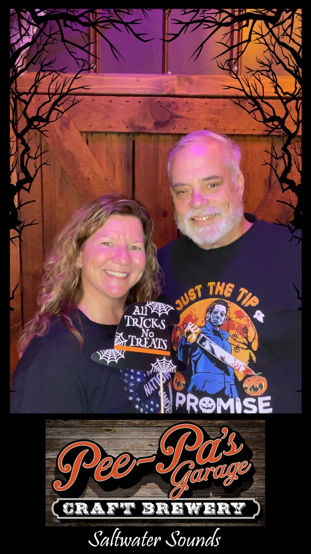 A man and a woman are posing for a picture in front of a wooden door.