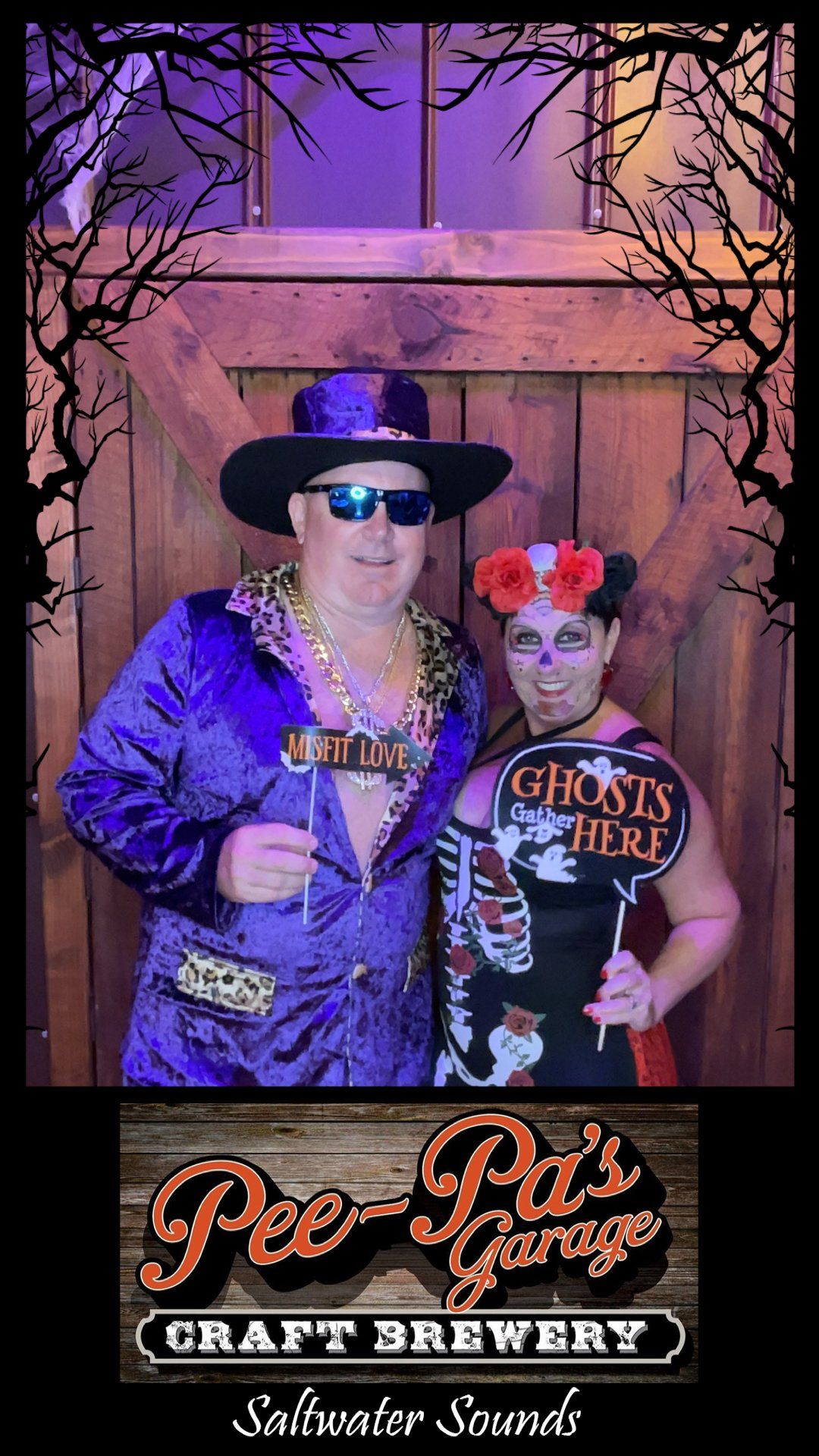 A man and a woman are posing for a picture in a photo booth.