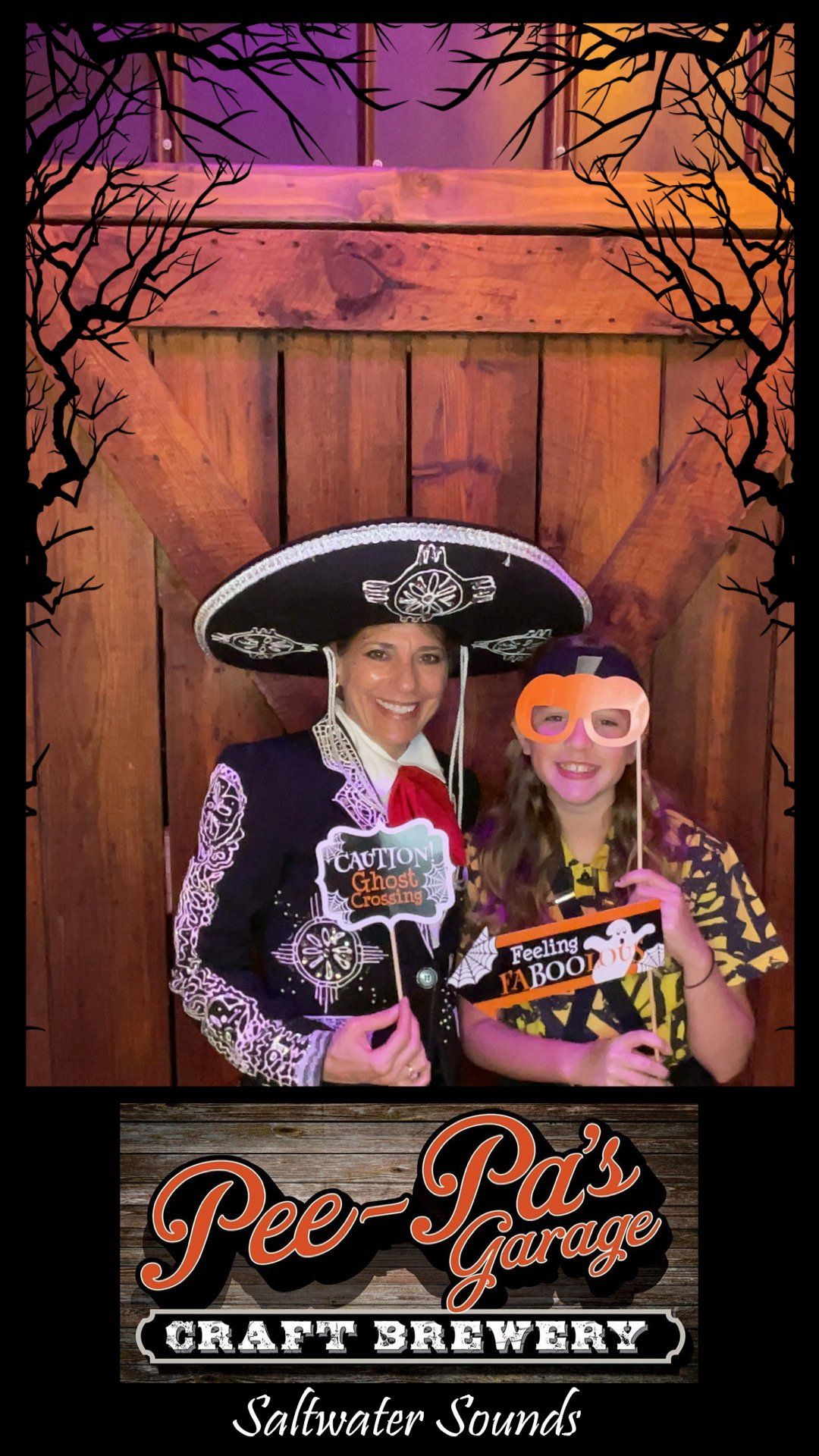 A woman and a girl are posing for a picture in a photo booth.