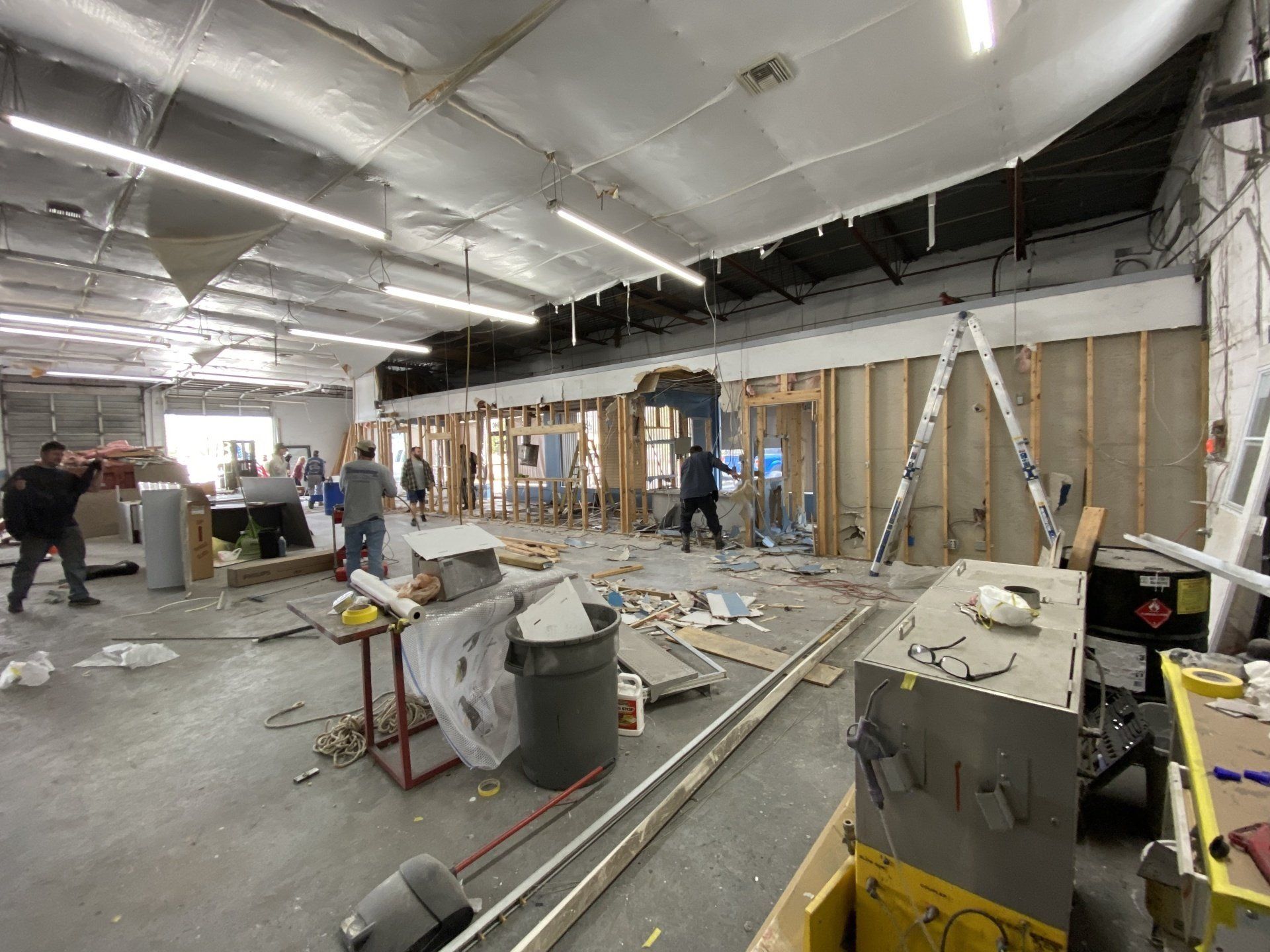A group of people are working on a building in a large room.
