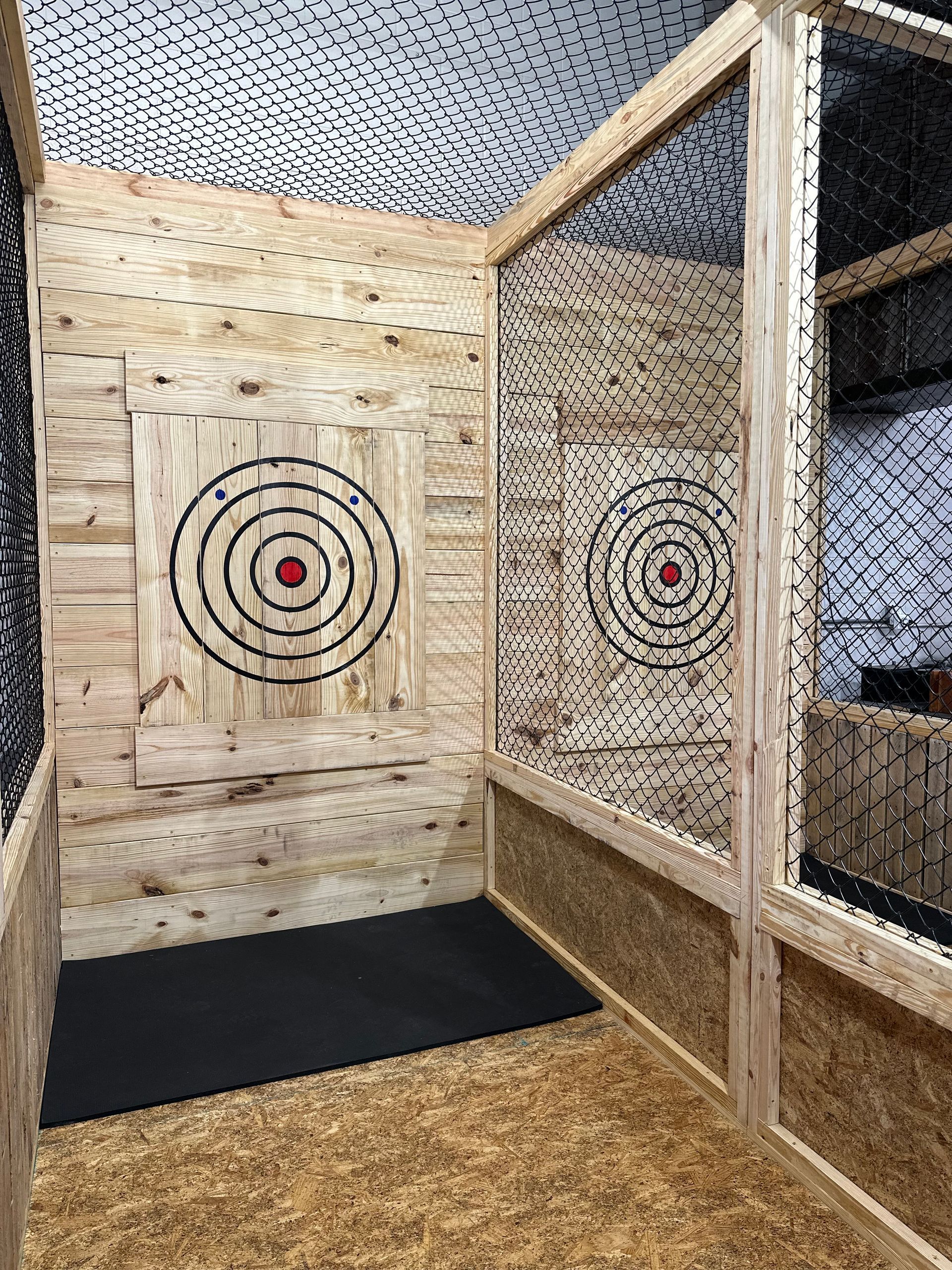 A room with two axes and a target on the wall.
