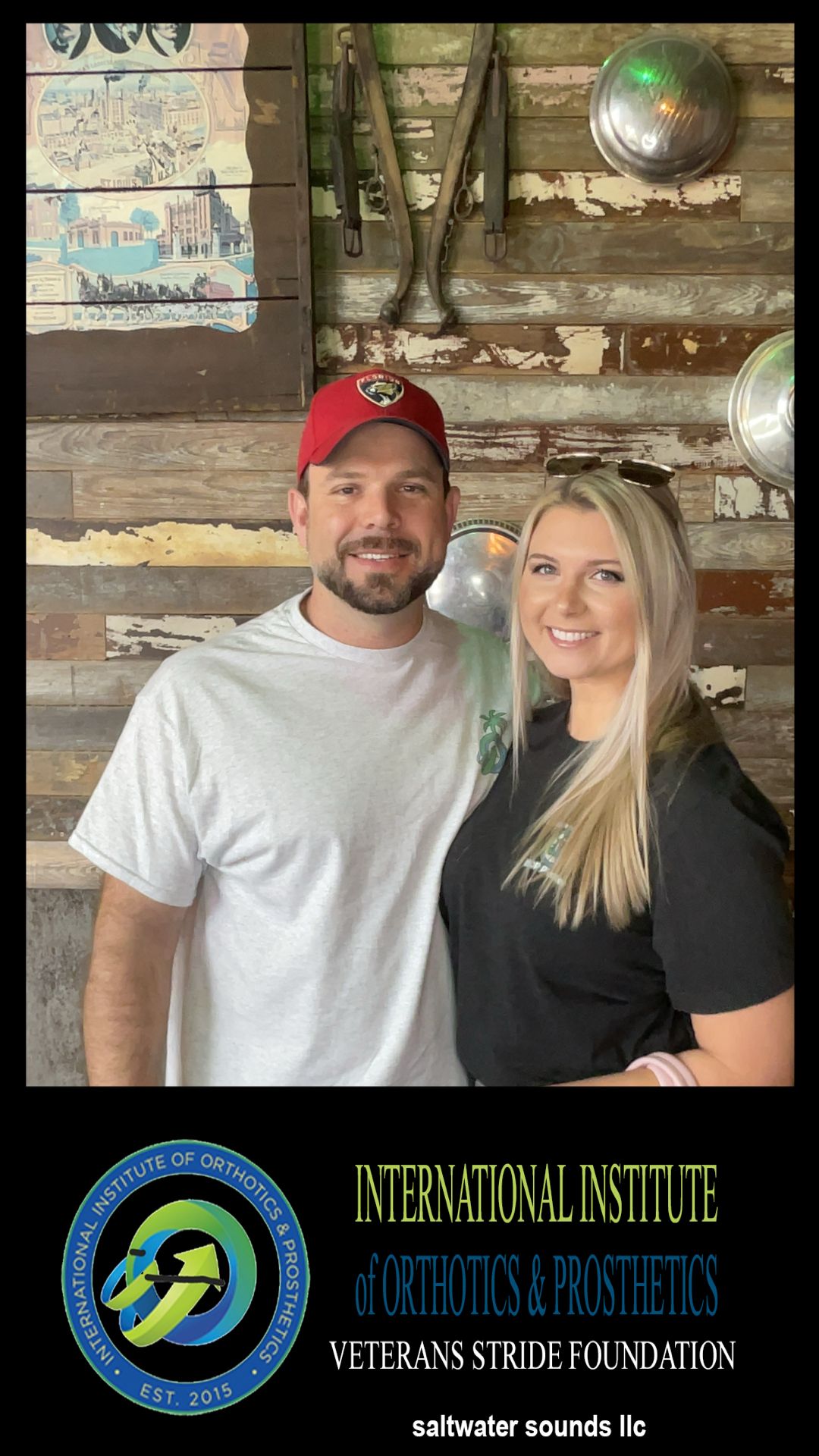 A man and a woman are posing for a picture in front of a wooden wall.