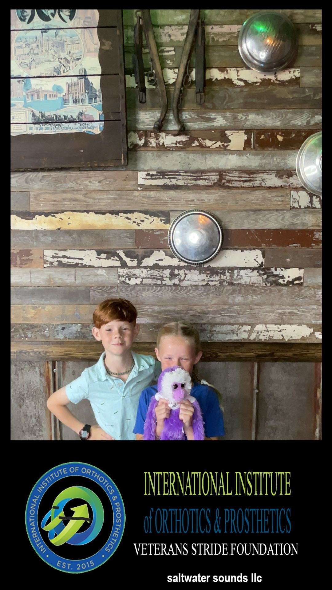 A boy and a girl are posing for a picture in front of a wooden wall.