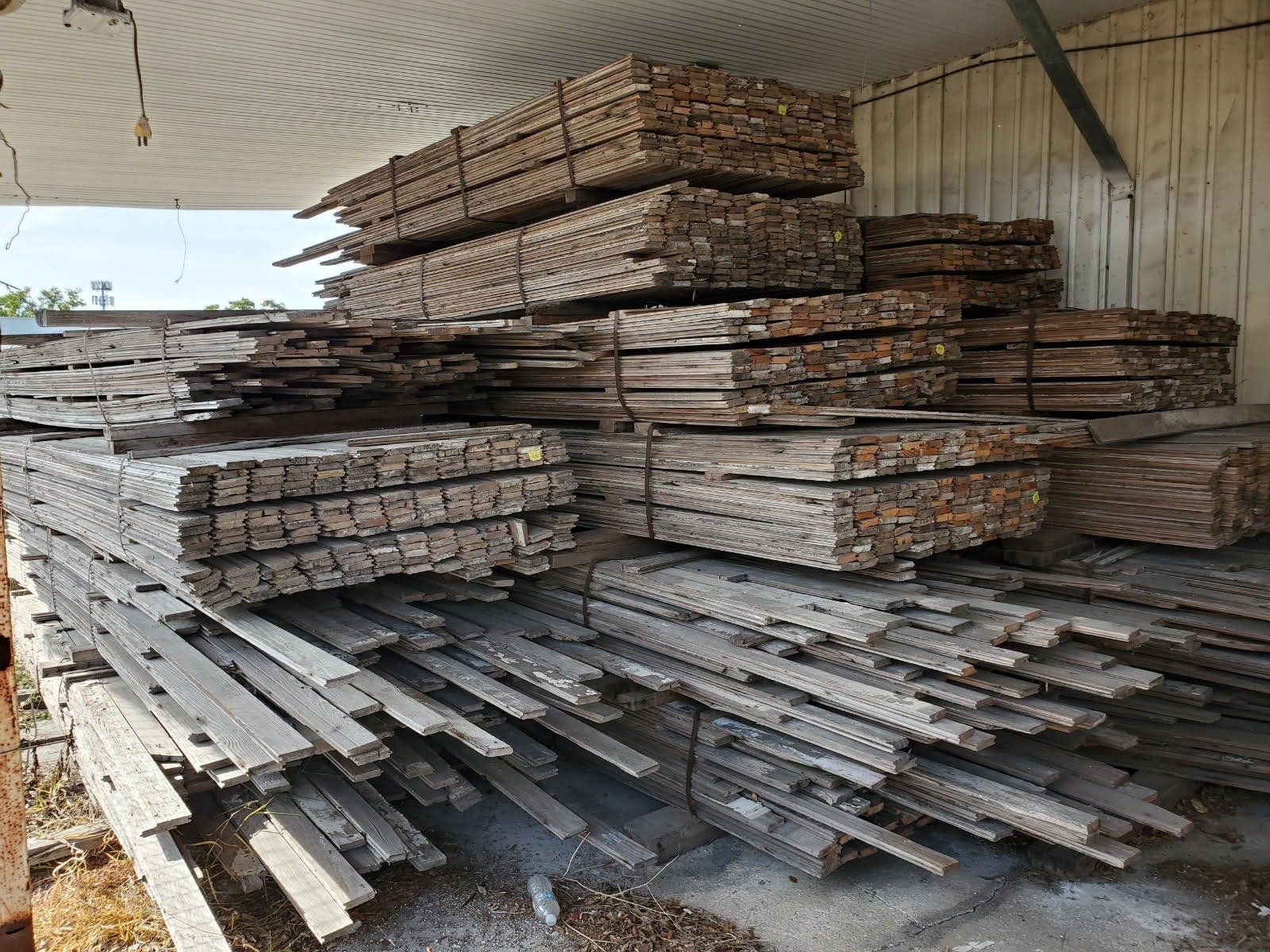 A pile of wood is stacked on top of each other in a warehouse.