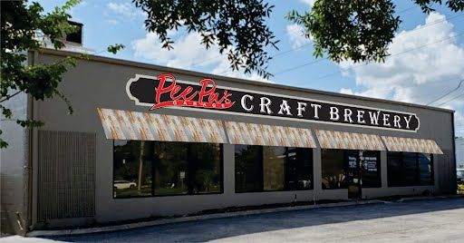 A large building with a sign that says craft brewery on it