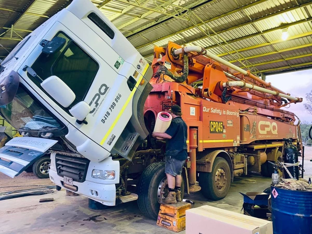 A Person Working on a Concrete Pump Truck — Traction Diesel Services in Clermont, QLD