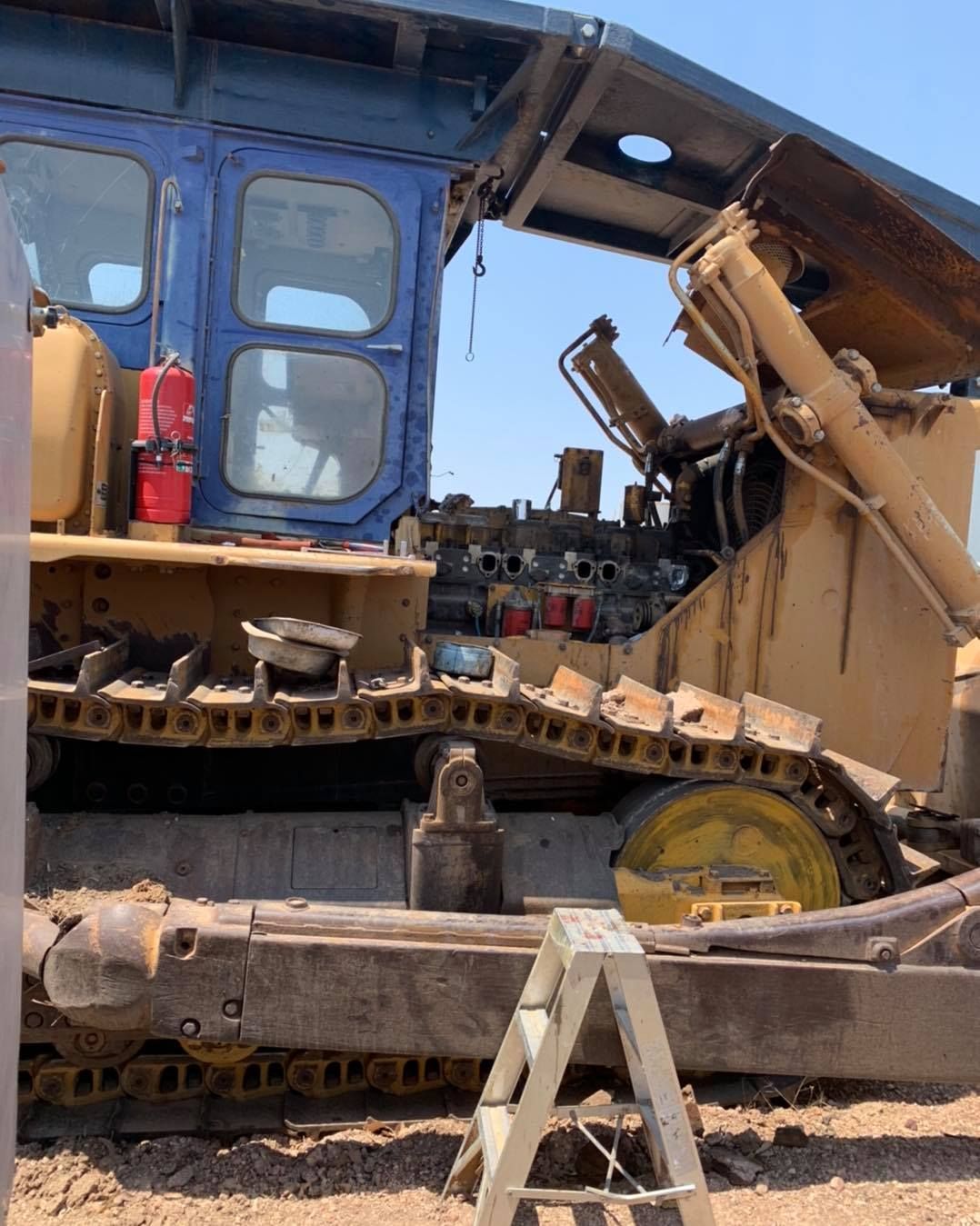 Yellow Bulldozer With Blue Cab and Open Engine Compartment — Traction Diesel Services in Clermont, QLD