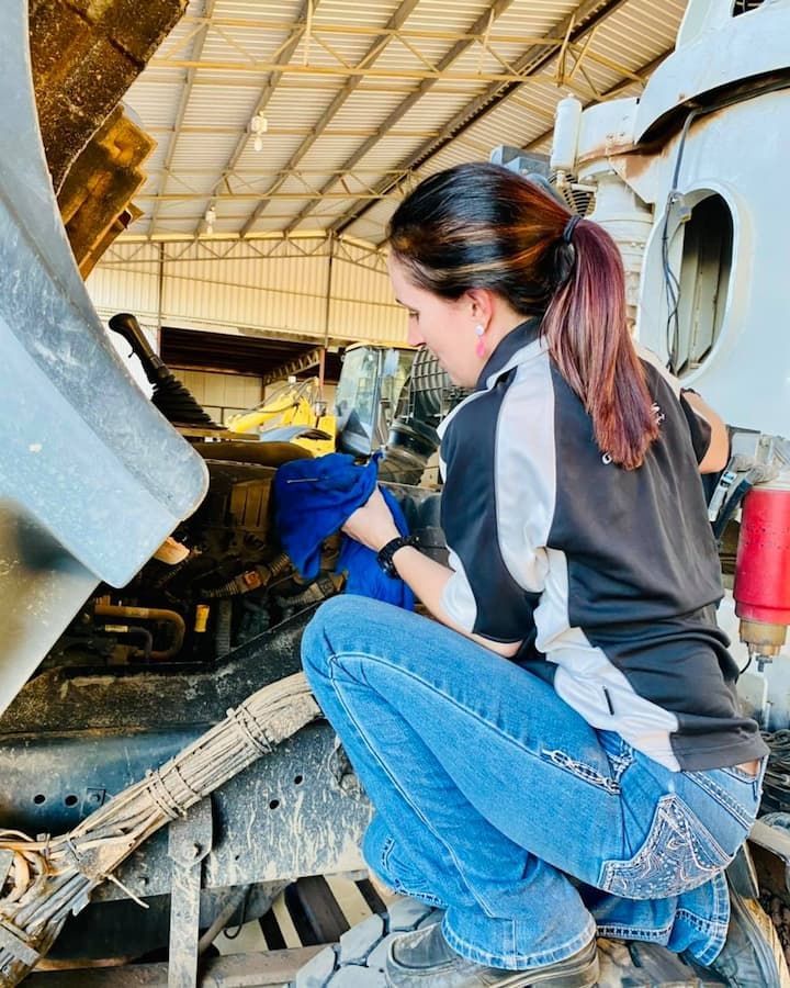 Woman in Work Clothes Working on a Truck Engine — Traction Diesel Services in Clermont, QLD