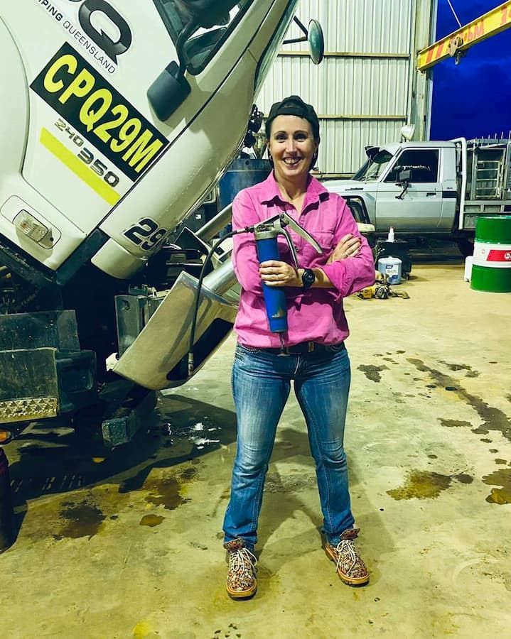 Woman in Pink Shirt and Jeans Holding a Tool — Traction Diesel Services in Clermont, QLD