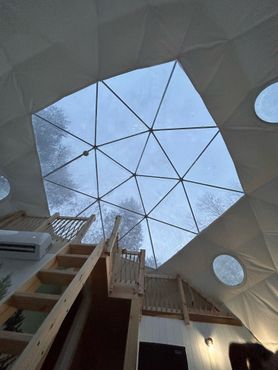 Looking up at the sky from inside a dome with stairs
