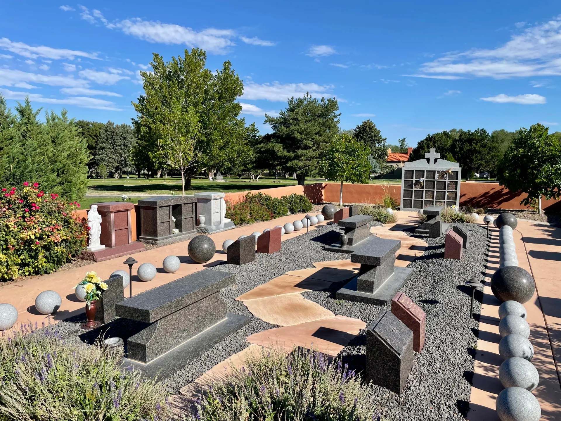 Large foyer with round wooden table, chandelier, and a vase of flowers.
