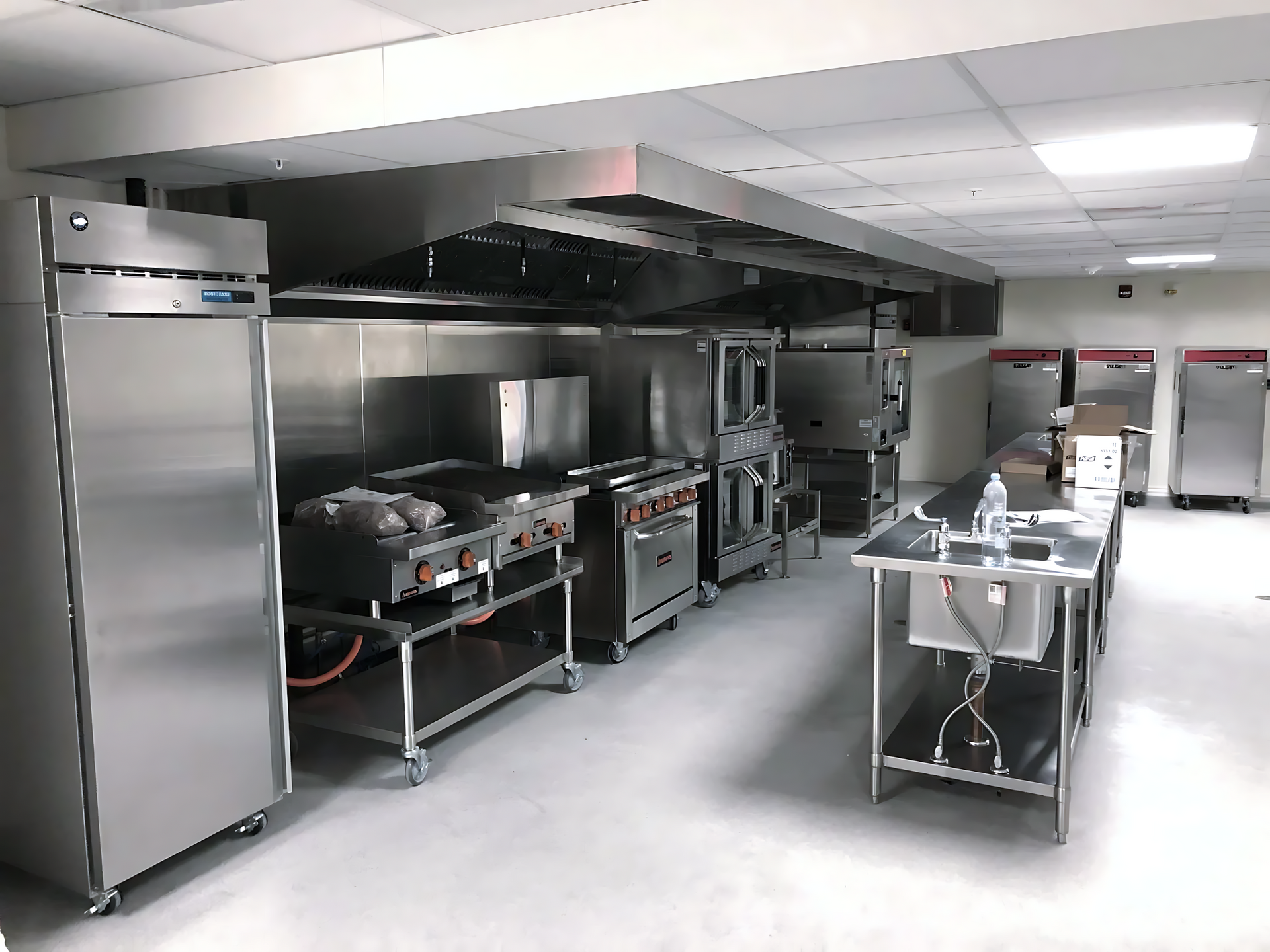 a kitchen with stainless steel appliances and a refrigerator
