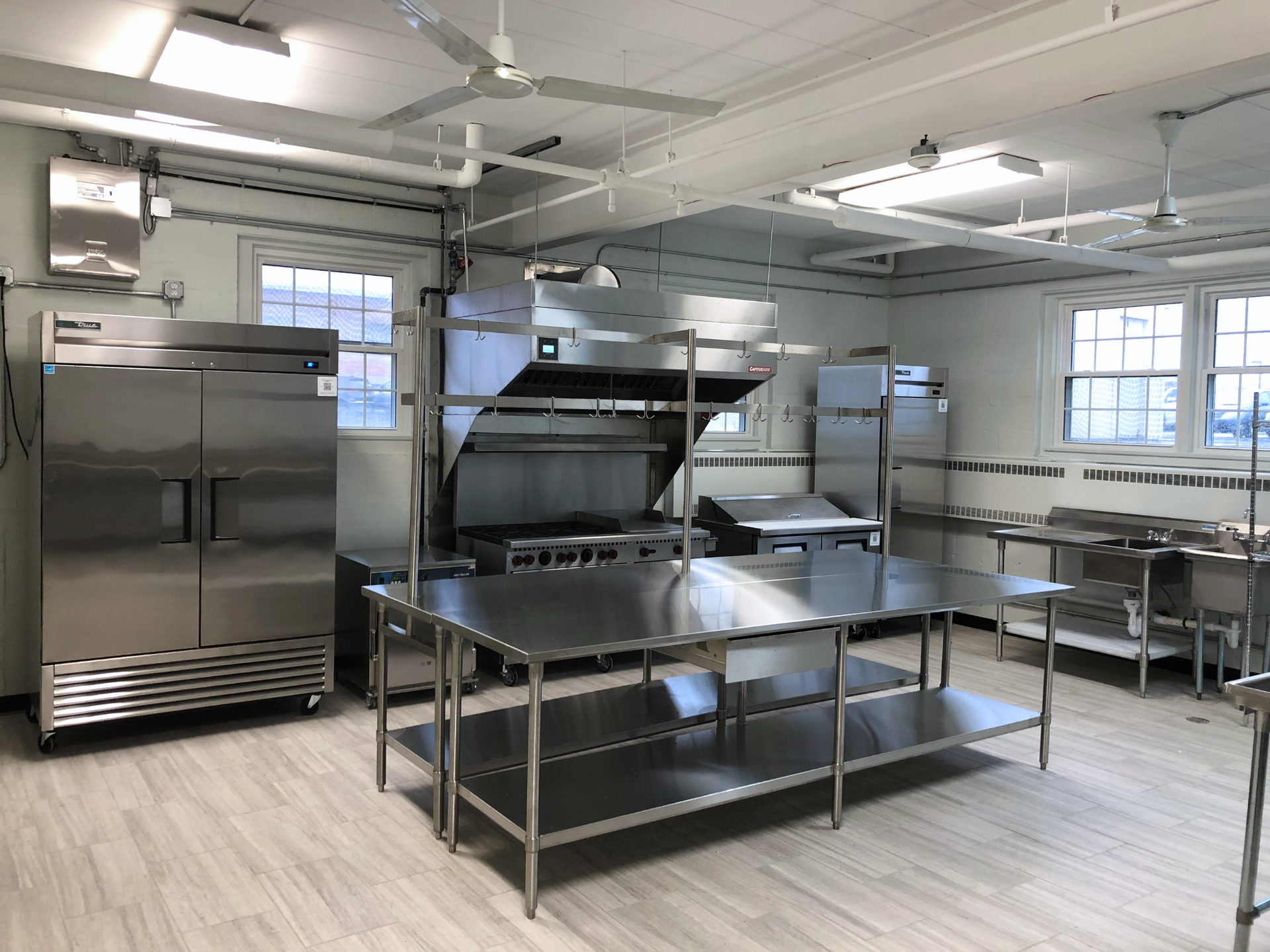 a kitchen with stainless steel appliances and a ceiling fan