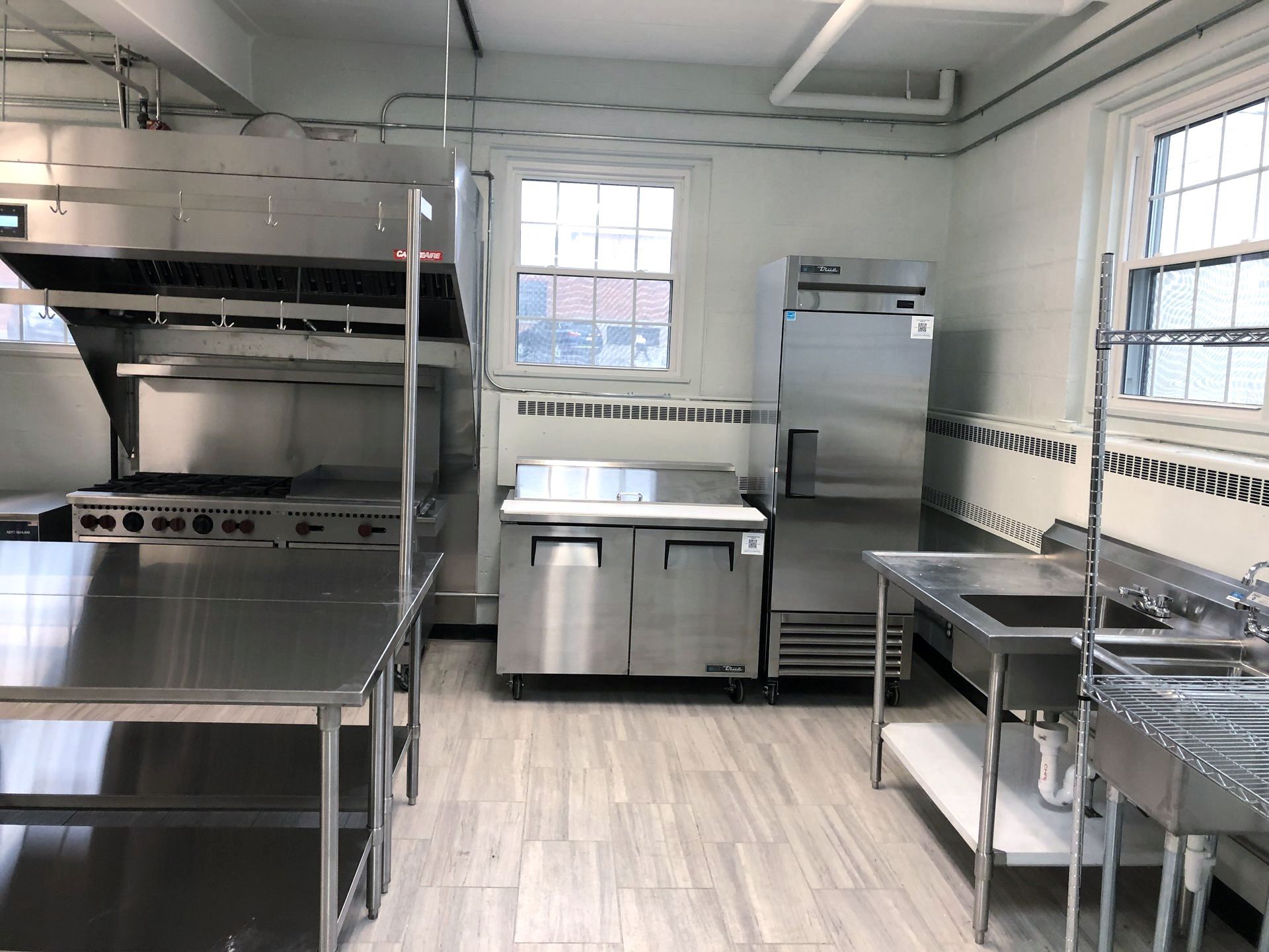 a kitchen with stainless steel appliances and a refrigerator that says 'arctic king' on it