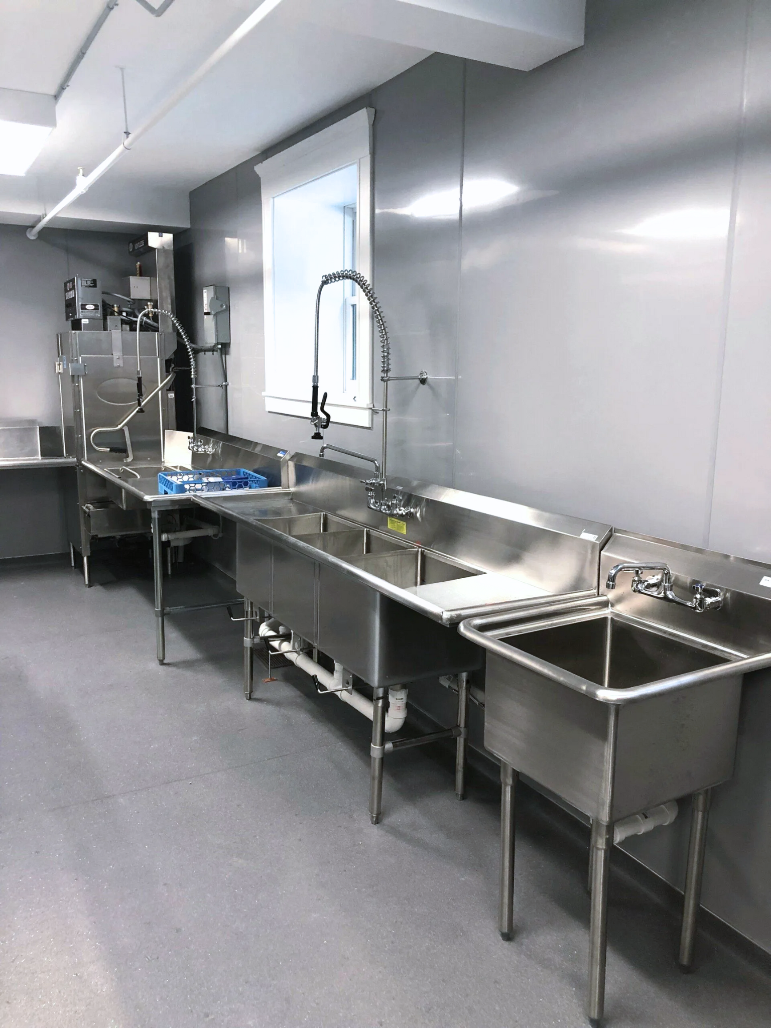 a kitchen with stainless steel sinks