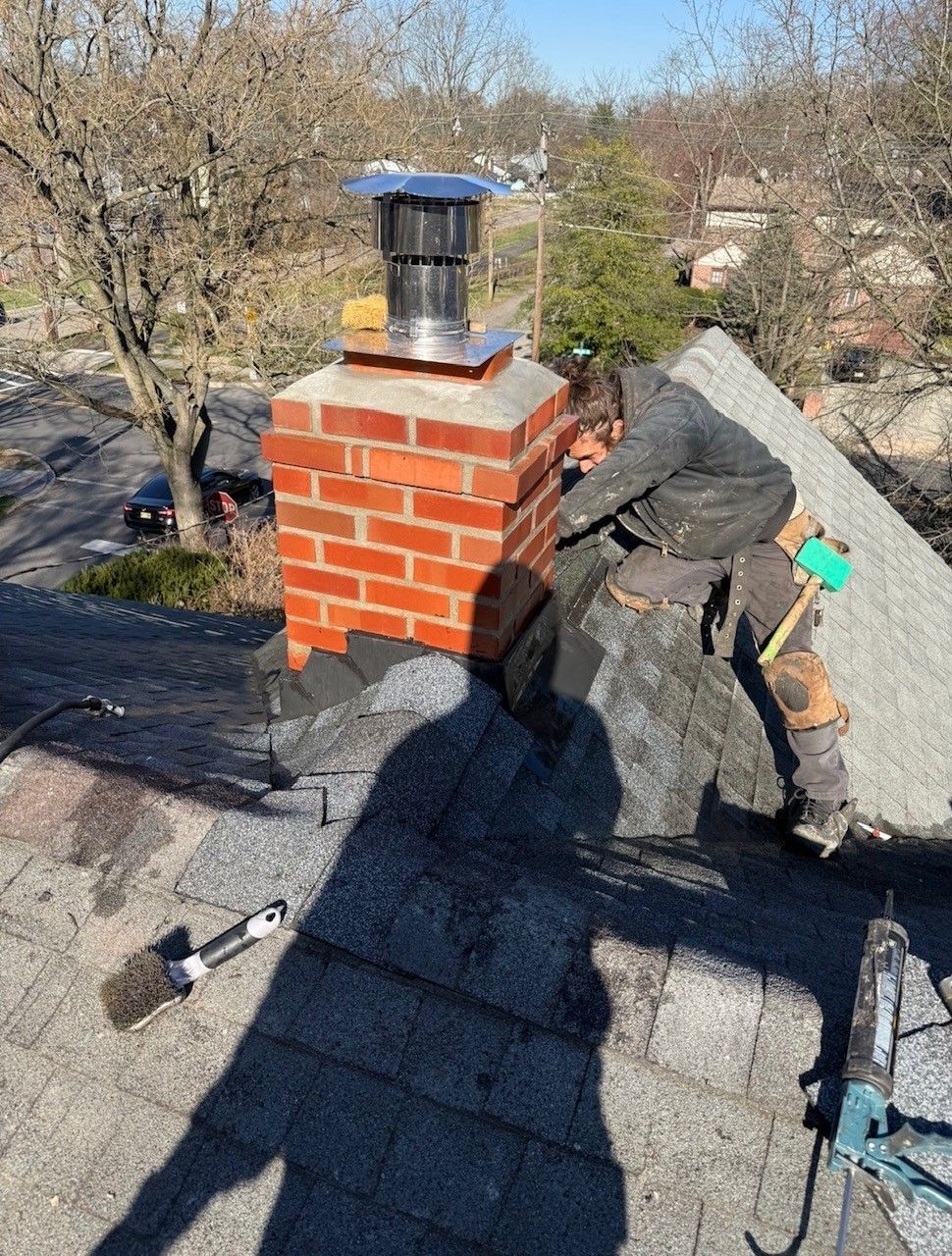 A man is cleaning a chimney with a brush
