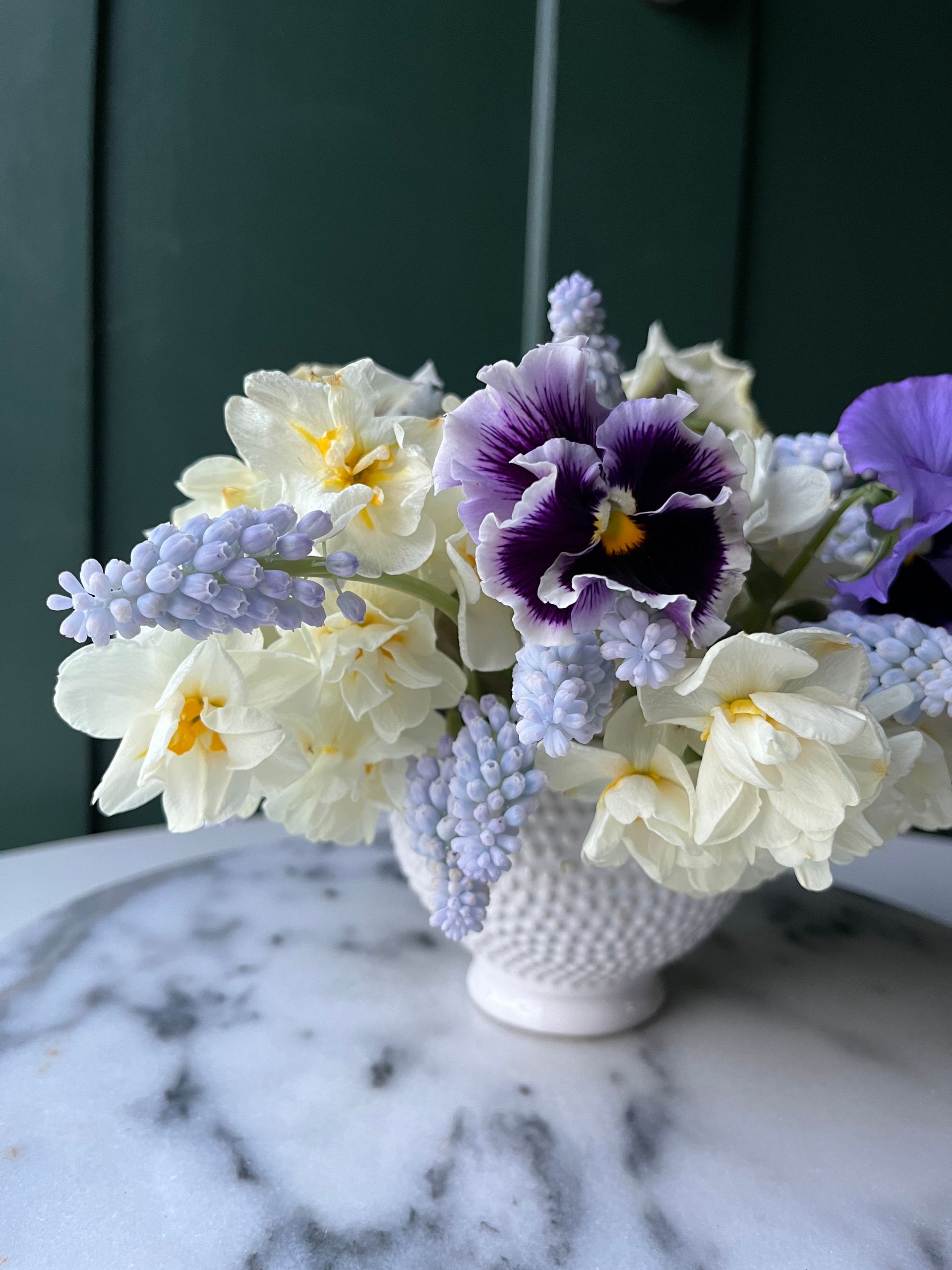 a compote arrangement with muscari, stock and pansy locally grown in Lancaster Ohio