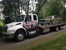 Classic car on flatbed tow truck — car hauling in Mankato, MN