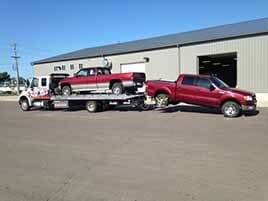 Trucks being towed on flatbed — towing services in mankato, MN