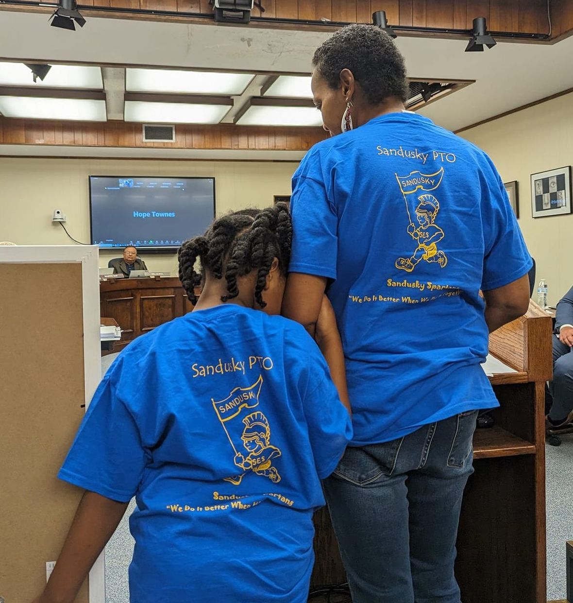 Latorya and her daughter while latorya spoke at a school board meeting