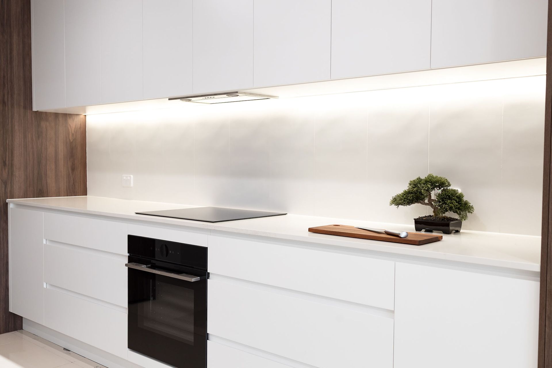 Modern White Kitchen With Built-in Oven, Stovetop, and Under-cabinet — Truline Cabinets In Tuchekoi, QLD