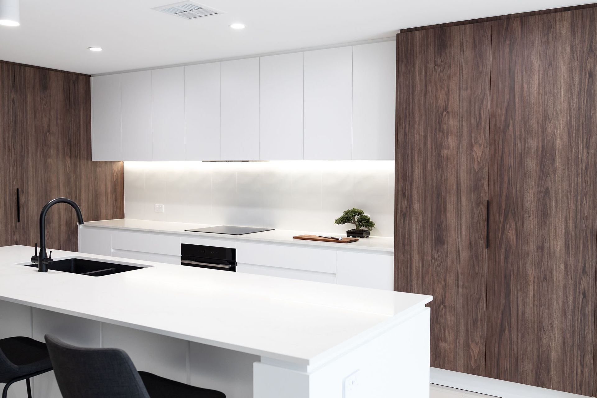 Modern Kitchen With White Countertops, Dark Wood Cabinets, and a Black Faucet — Truline Cabinets In Tuchekoi, QLD